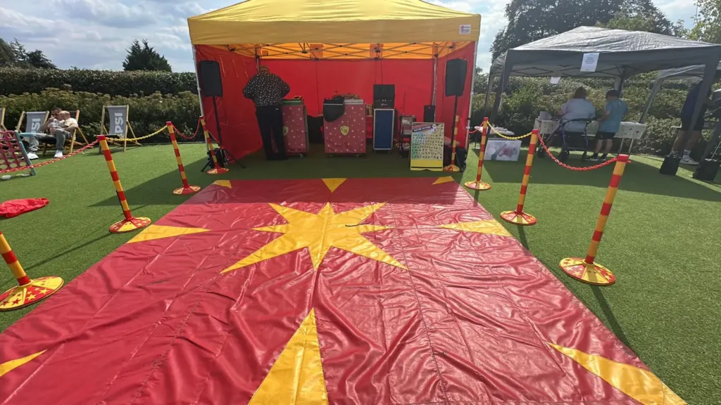 Outdoor circus stage with a star-patterned performance mat, ready for the show