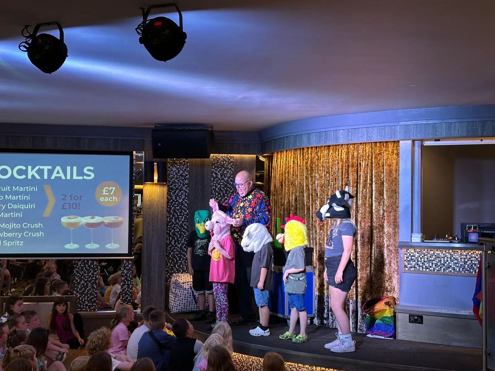 Children joining Chunkie on stage at a holiday park family show