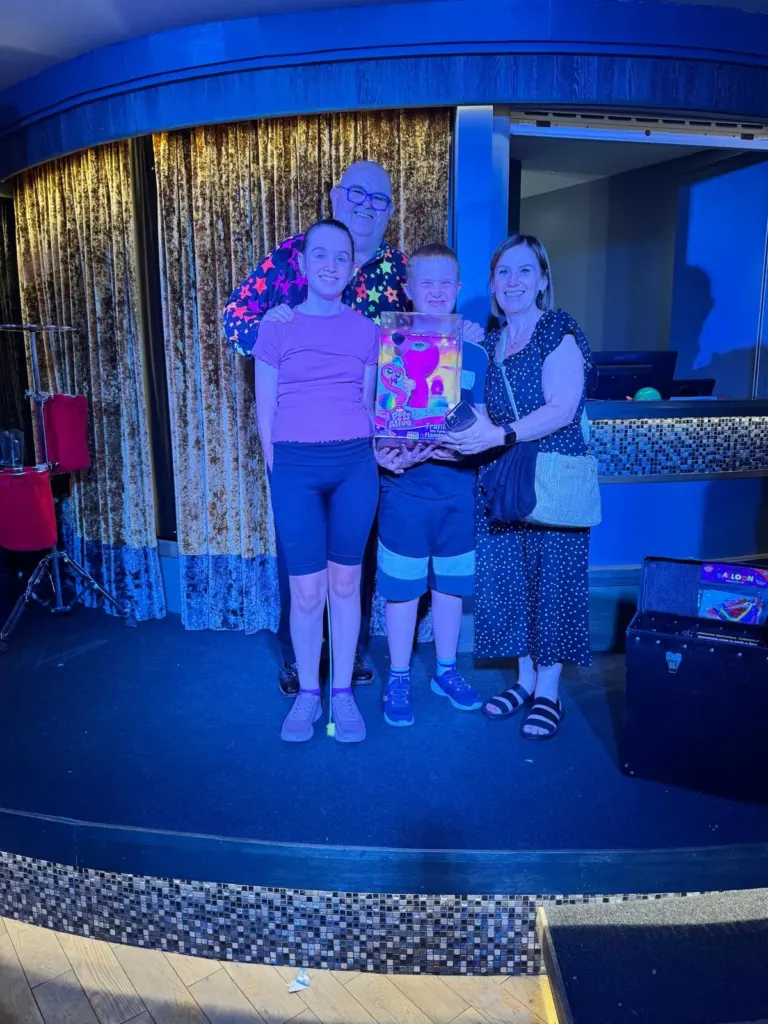 A family posing for photos with Chunkie after the show