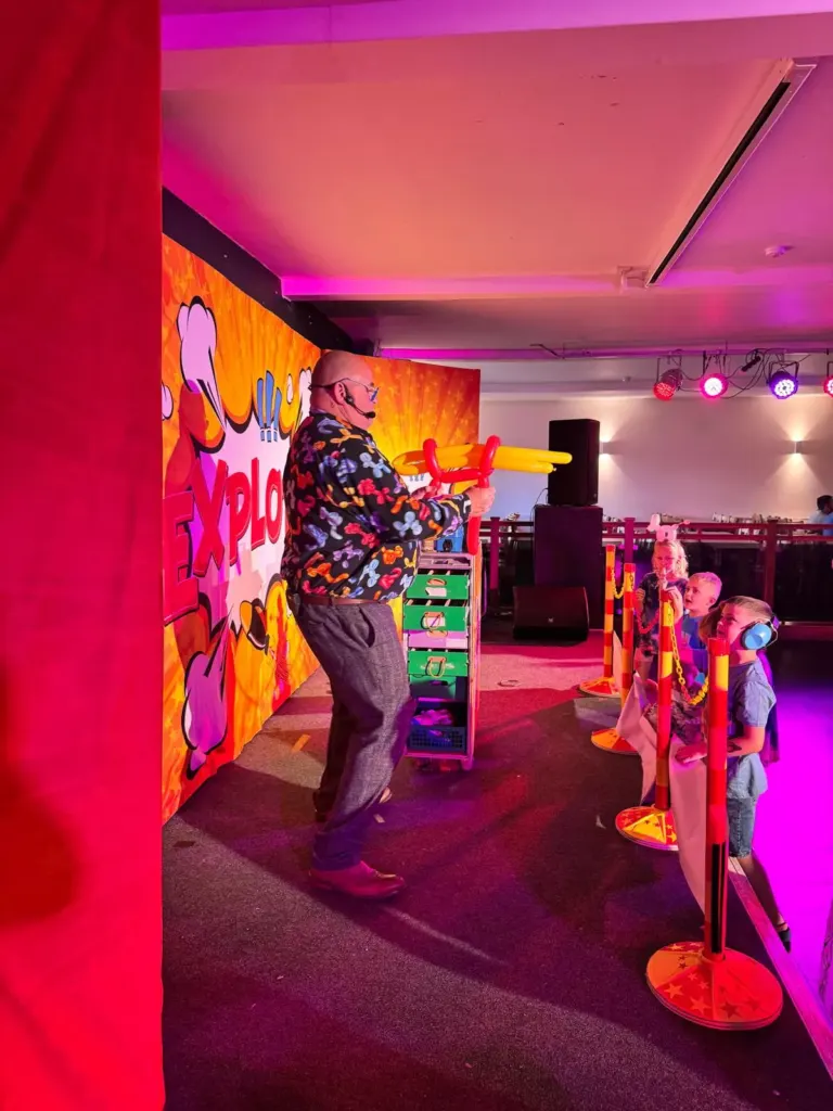 Chunkie on stage under pink and purple show lights