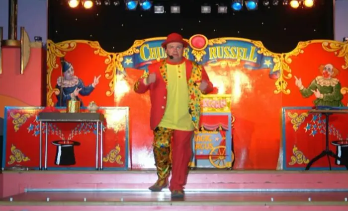 Tommy Tumble performing on a colourful circus-themed stage
