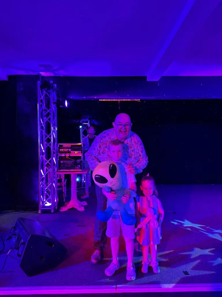 Glow-in-the-dark UV stage show with a costume character